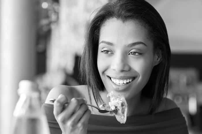 woman eating and smiling