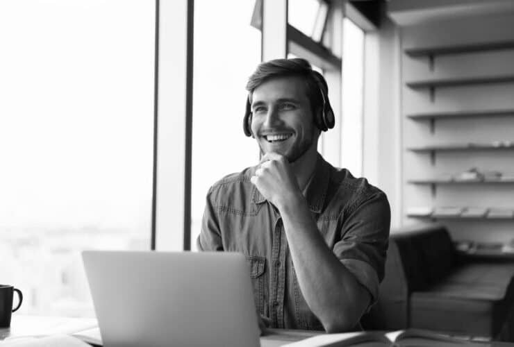 handsome man with straight teeth smiling in cafe